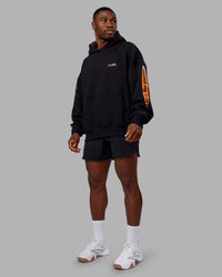 Man wearing Hyped Unisex Oversized Hoodie - Black-Vibrant Orange | Model:Sam | Size:L | Thumbnail Index: 10