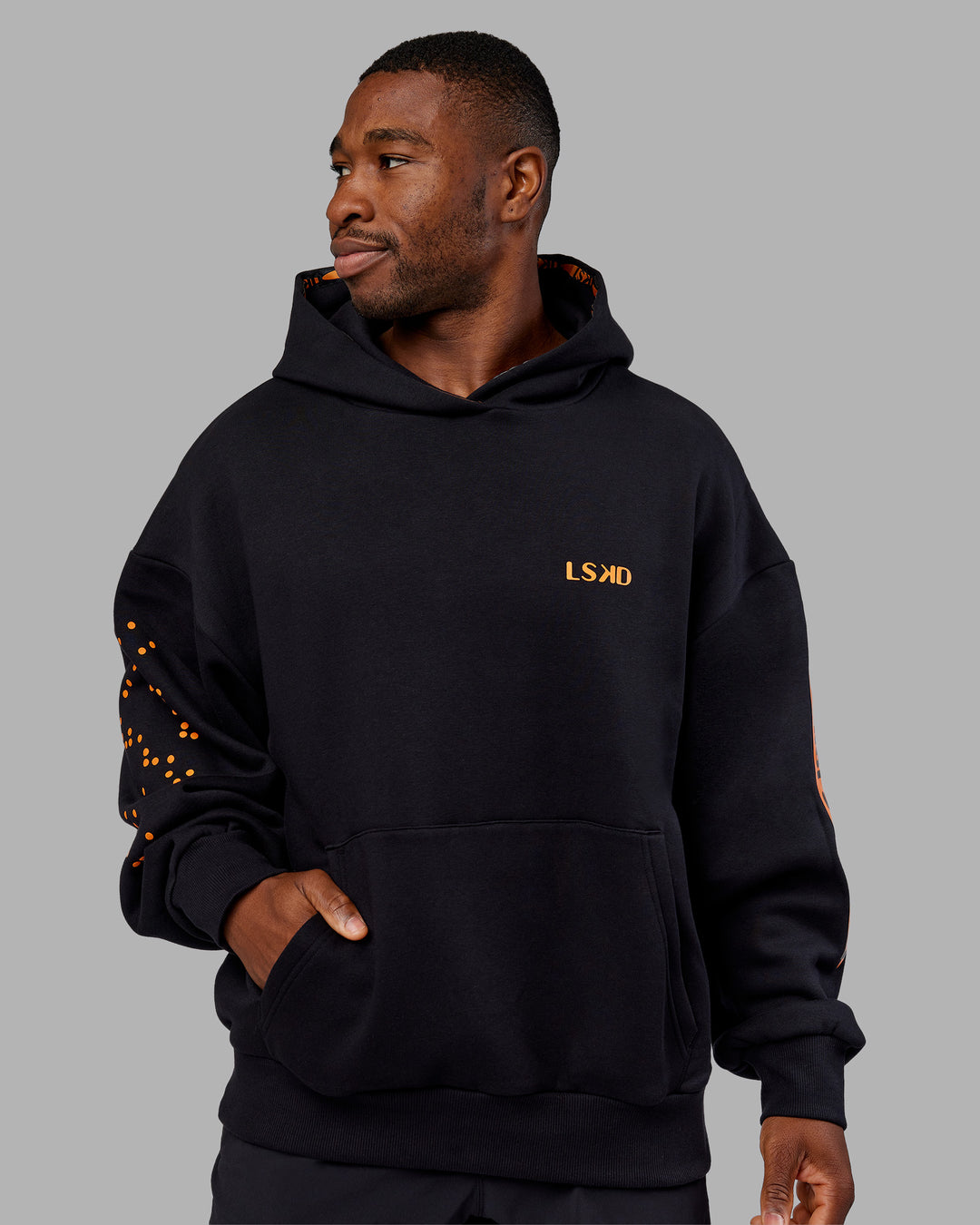Man wearing Hyped Unisex Oversized Hoodie - Black-Vibrant Orange | Model:Sam | Size:L - view 8