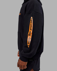Man wearing Hyped Unisex Oversized Hoodie - Black-Vibrant Orange | Model:Sam | Size:L | Thumbnail Index: 1