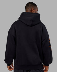 Man wearing Hyped Unisex Oversized Hoodie - Black-Vibrant Orange | Model:Sam | Size:L | Thumbnail Index: 3