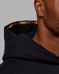 Man wearing Hyped Unisex Oversized Hoodie - Black-Vibrant Orange | Model:Sam | Size:L | Thumbnail Index: 6