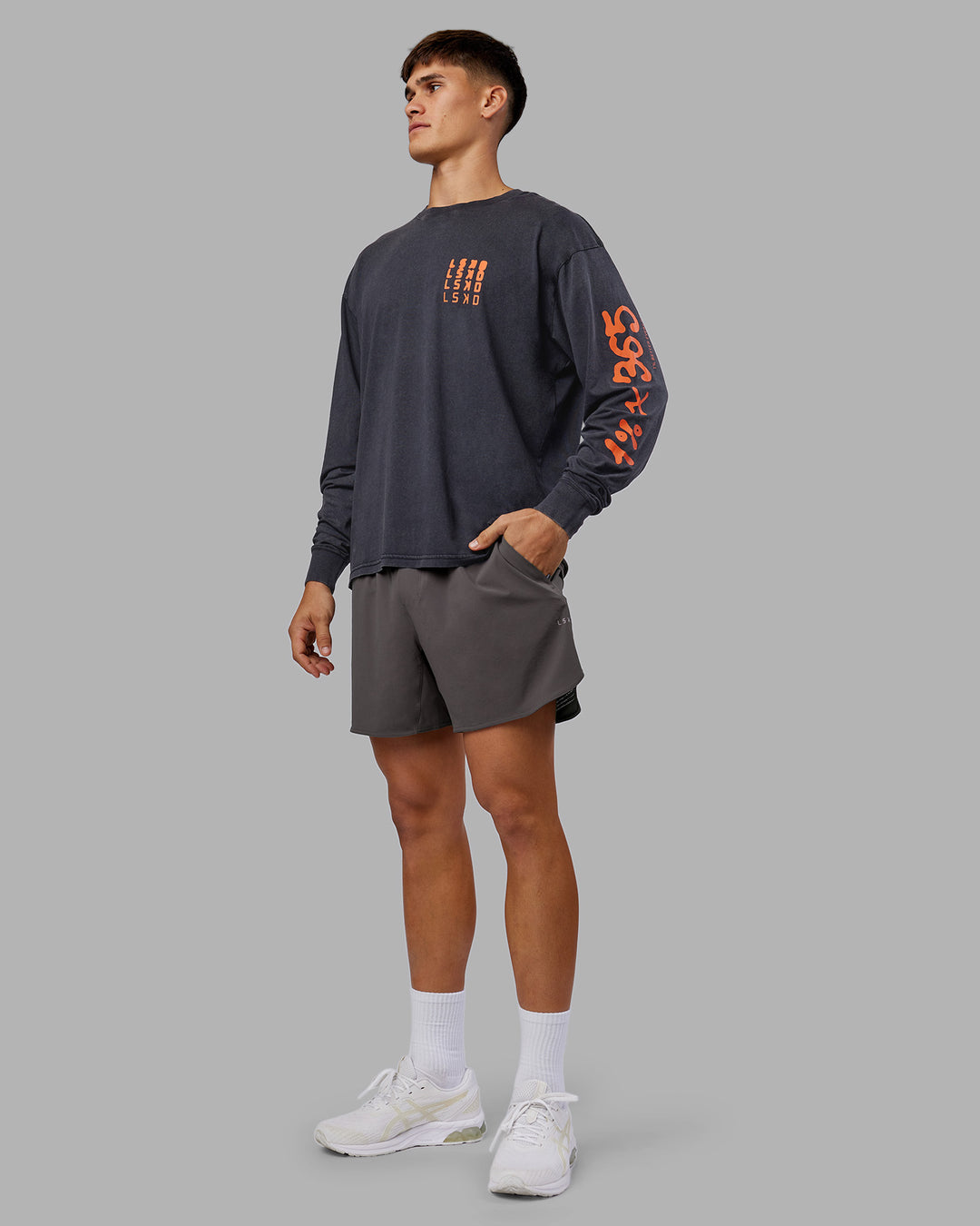 Man wearing Inferno Journey FLXCotton Oversized Long Sleeve Tee - Washed Black-Ultra Orange | Model:Jackson | Size:L - view 12