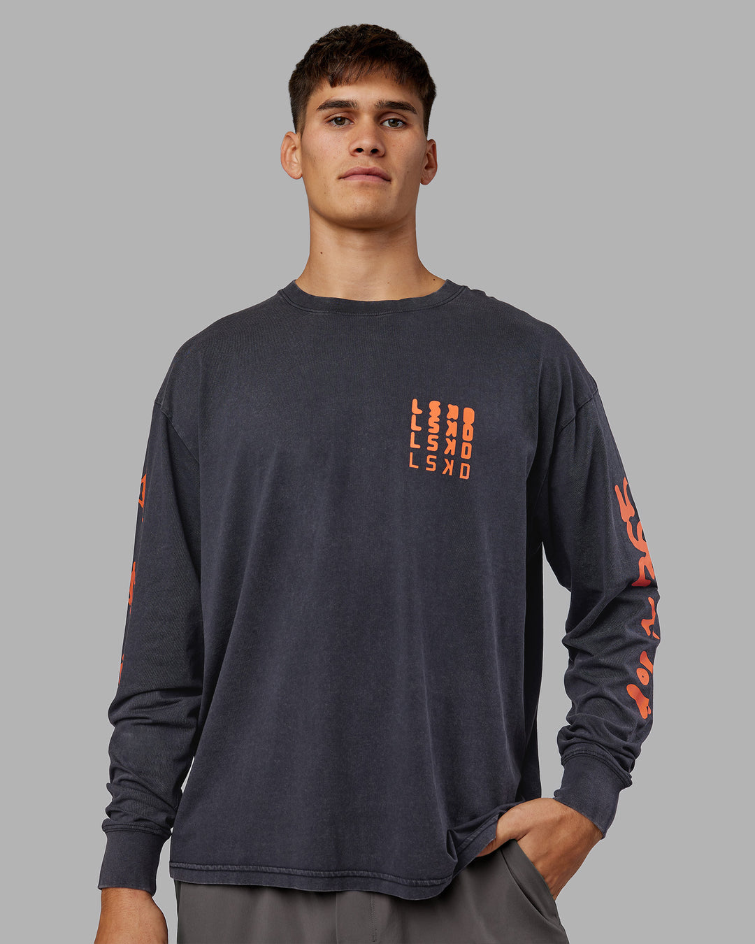 Man wearing Inferno Journey FLXCotton Oversized Long Sleeve Tee - Washed Black-Ultra Orange | Model:Jackson | Size:L - view 4