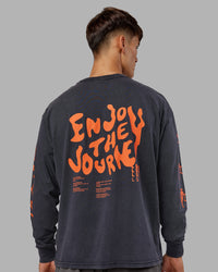 Man wearing Inferno Journey FLXCotton Oversized Long Sleeve Tee - Washed Black-Ultra Orange | Model:Jackson | Size:L | Thumbnail Index: 0
