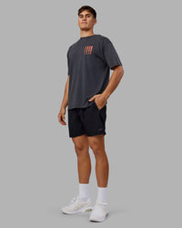 Man wearing Inferno Journey FLXCotton Oversized Tee - Black Washed-Ultra Orange | Model:Jackson | Size:L | Thumbnail Index: 5