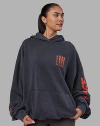 Woman wearing Journey Washed Unisex Oversize Hoodie - Black-Ultra Orange | Model:Rhiley | Size:L | Thumbnail Index: 2