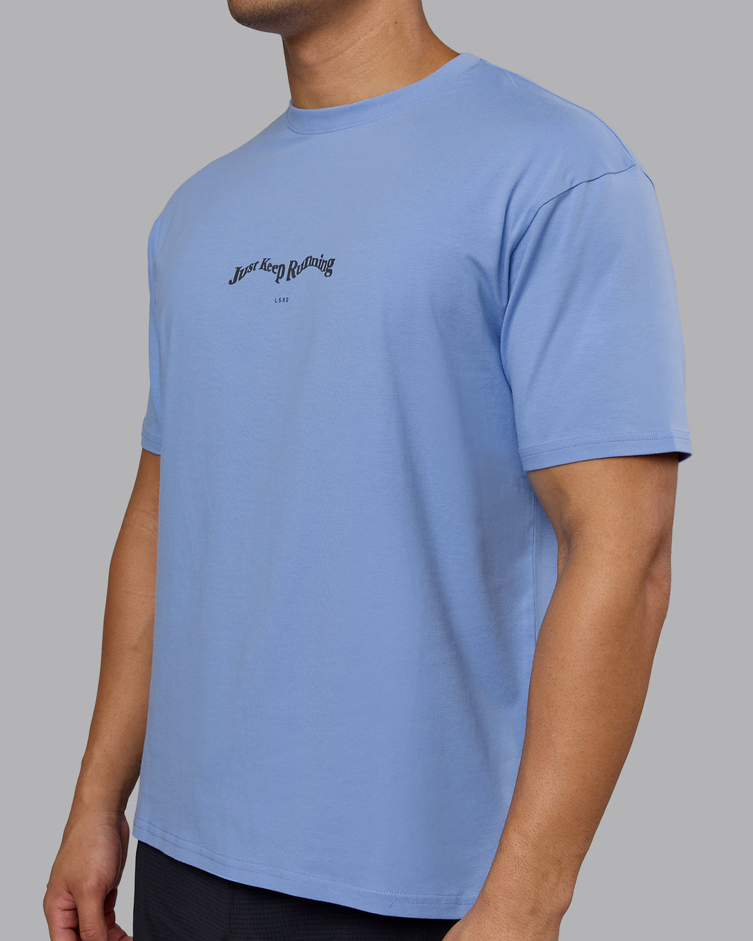 Man wearing Just Run FLXCotton Oversized Tee - Soft Blue-Dark Storm | Model:Kaelyb | Size:L - view 9
