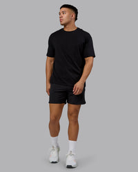 Man wearing Lifting Club FLXCotton Tee Oversize - Black-Ultra Orange | Model:Kaelyb | Size:L | Thumbnail Index: 4