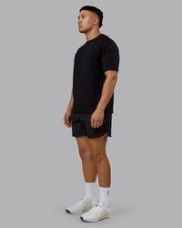 Man wearing Lifting Club FLXCotton Tee Oversize - Black-Ultra Orange | Model:Kaelyb | Size:L | Thumbnail Index: 10