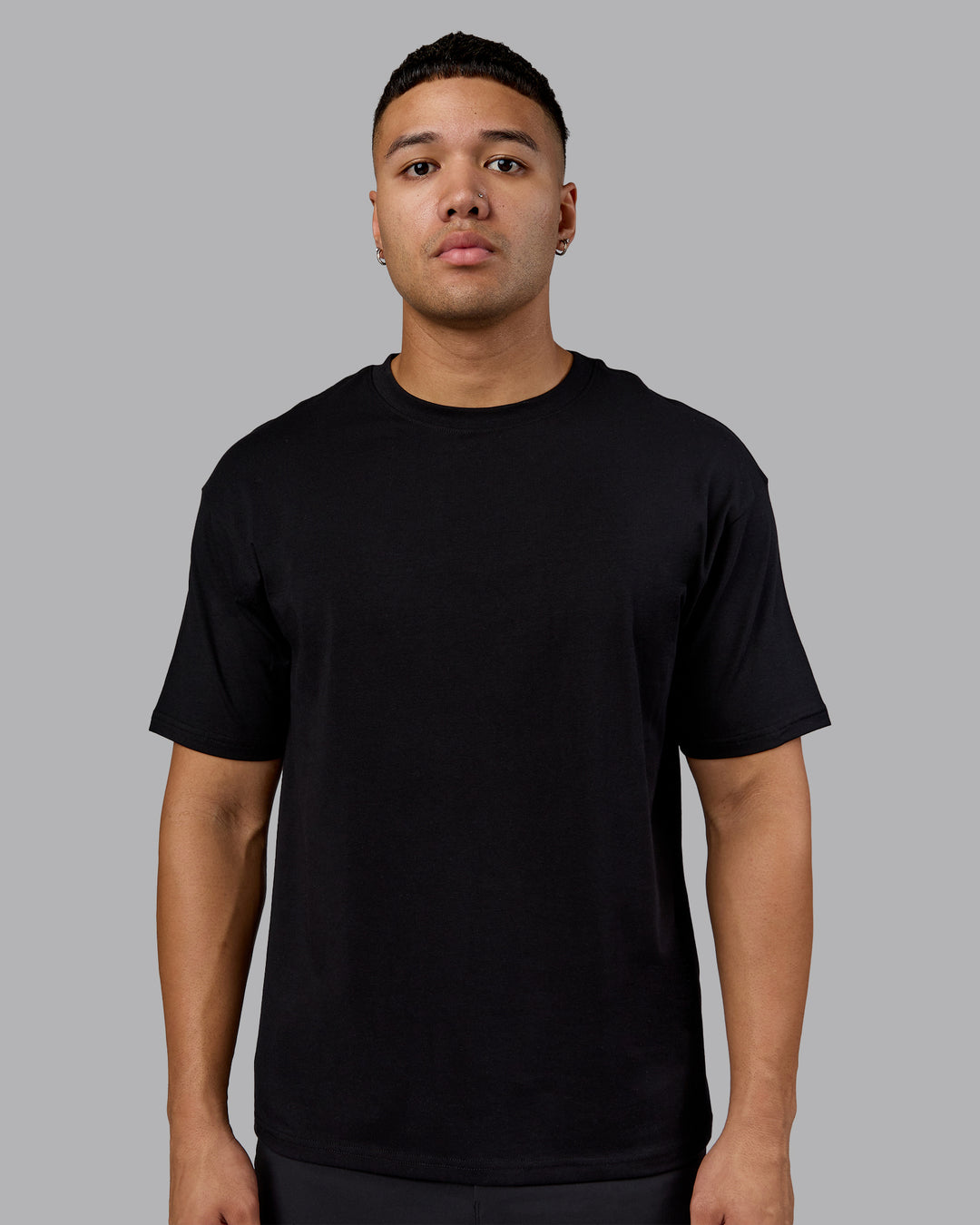 Man wearing Lifting Club FLXCotton Tee Oversize - Black-Ultra Orange | Model:Kaelyb | Size:L - view 3