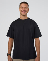 Man wearing Lifting Club FLXCotton Tee Oversize - Black-Black | Model:Nikola | Size:L | Thumbnail Index: 1