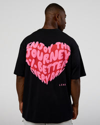 Man wearing Love the Journey FLXCotton Oversized Tee - Black-Flame | Model:Sam | Size:L | Thumbnail Index: 1