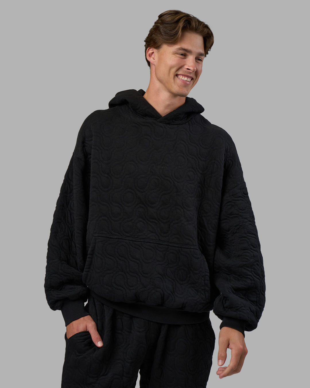 Man wearing MVP Quilted Oversized Hoodie - Black-Geometric | Model:Brandon | Size:L - view 9