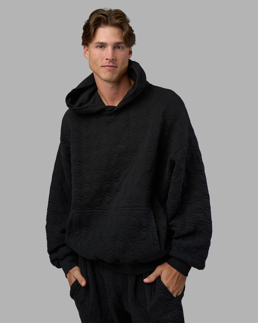 Man wearing MVP Quilted Oversized Hoodie - Black-Geometric | Model:Brandon | Size:L - view 3