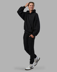 Man wearing MVP Quilted Oversized Hoodie - Black-Geometric | Model:Brandon | Size:L | Thumbnail Index: 3