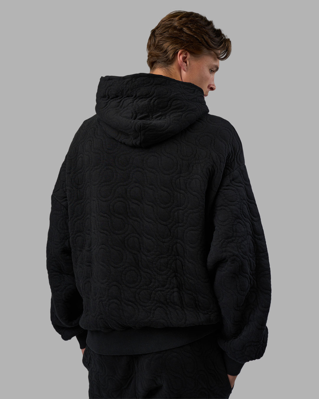 Man wearing MVP Quilted Oversized Hoodie - Black-Geometric | Model:Brandon | Size:L - view 7