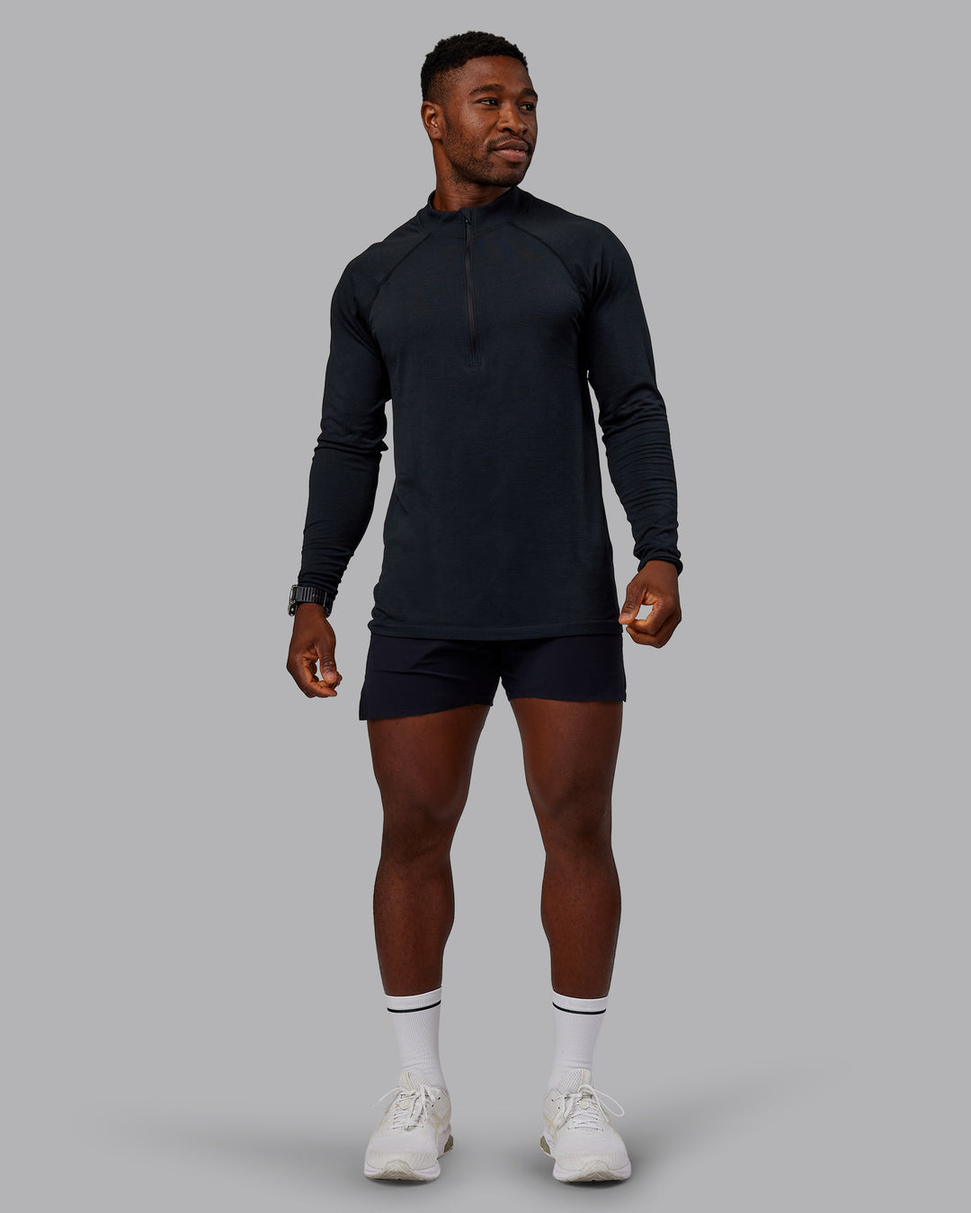 Man wearing AeroFLX+ Seamless Half Zip Long Sleeve Tee - Black/Black | Model:Sam | Size:L - view 1