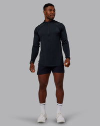 Man wearing AeroFLX+ Seamless Half Zip Long Sleeve Tee - Black/Black | Model:Sam | Size:L | Thumbnail Index: 0