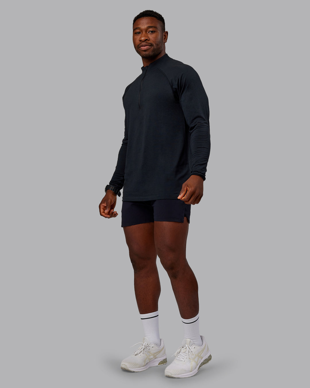Man wearing AeroFLX+ Seamless Half Zip Long Sleeve Tee - Black/Black | Model:Sam | Size:L - view 3