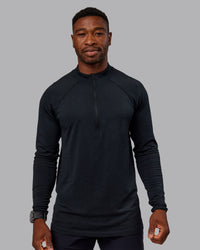 Man wearing AeroFLX+ Seamless Half Zip Long Sleeve Tee - Black/Black | Model:Sam | Size:L | Thumbnail Index: 1