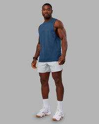 Woman wearing AeroFLX+ Seamless Muscle Tank - Indigo | Model:Sam | Size:L | Thumbnail Index: 1