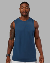 Woman wearing AeroFLX+ Seamless Muscle Tank - Indigo | Model:Sam | Size:L | Thumbnail Index: 0