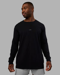 Man wearing Base FLXCotton Long Sleeve Tee - Black | Model:Sam | Size:L | Thumbnail Index: 0