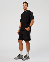 Man wearing Offset Heavyweight Unisex Oversized Tee - Black Washed-Castlerock | Model:Liam | Size:L | Thumbnail Index: 5
