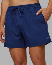 Man wearing Rep 5" Performance Short - Midnight Blue | Model:Jackson | Size:L | Thumbnail Index: 1