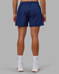 Man wearing Rep 5" Performance Short - Midnight Blue | Model:Jackson | Size:L | Thumbnail Index: 3
