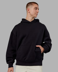 Man wearing Rise & Lift Hoodie Oversized - Black-White | Model:Tom | Size:L | Thumbnail Index: 2