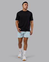 Man wearing RUN CLUB FLXCotton Tee Oversize - Black-Reflective | Model:Kaelyb | Size:L | Thumbnail Index: 4