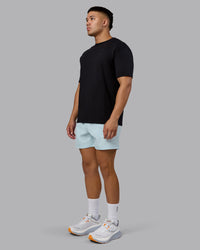 Man wearing RUN CLUB FLXCotton Tee Oversize - Black-Reflective | Model:Kaelyb | Size:L | Thumbnail Index: 10