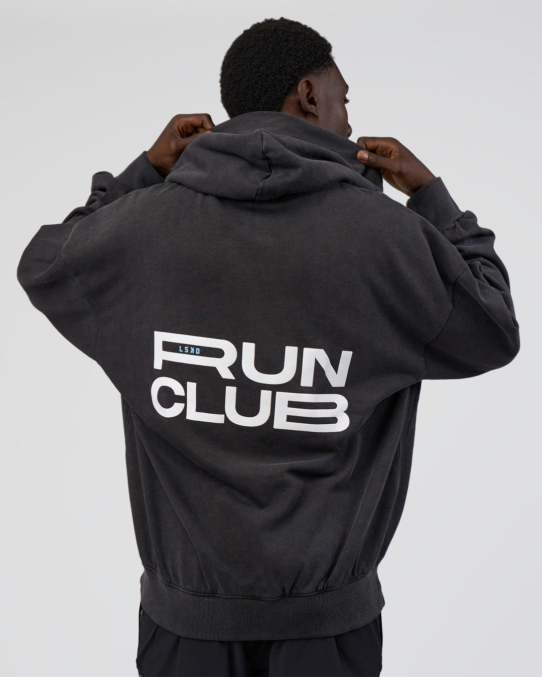 Man wearing Runner’s Unisex Oversized Hoodie - Black Washed-White | Model:Paabio | Size:L - view 3
