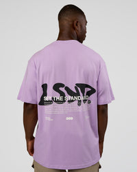 Man wearing Standard Issue FLXCotton Oversized Tee - Pale Lilac-Black | Model:Sam | Size:L | Thumbnail Index: 1