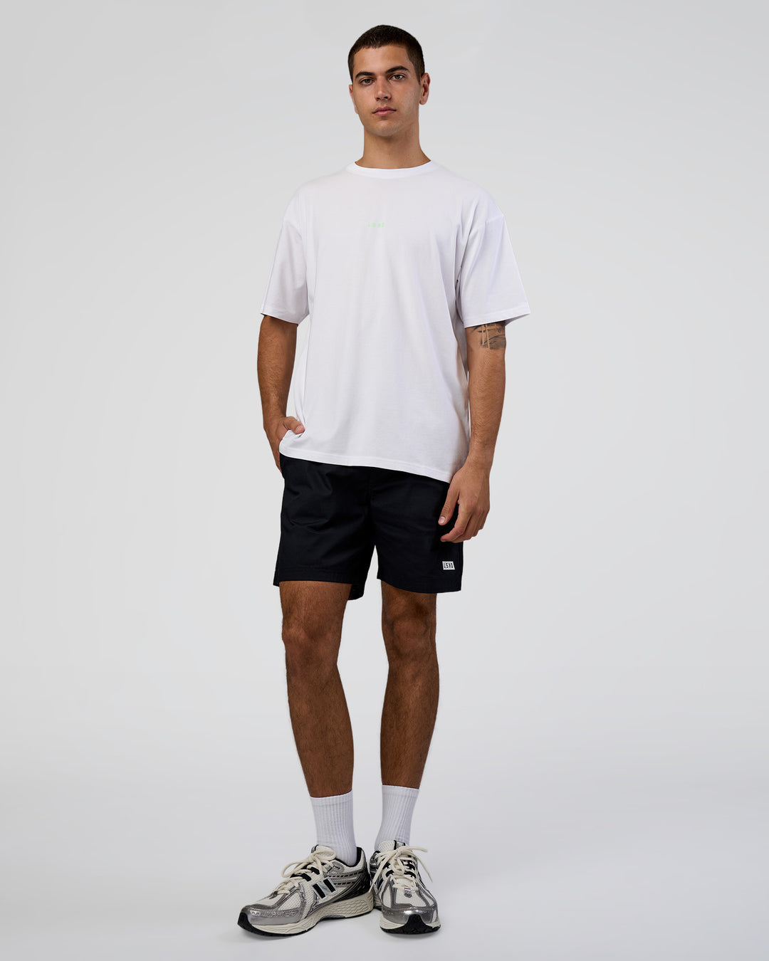 Man wearing Together We Rise FLXCotton Oversized Tee - White-Solar Lime | Model:Zoran | Size:L - view 2