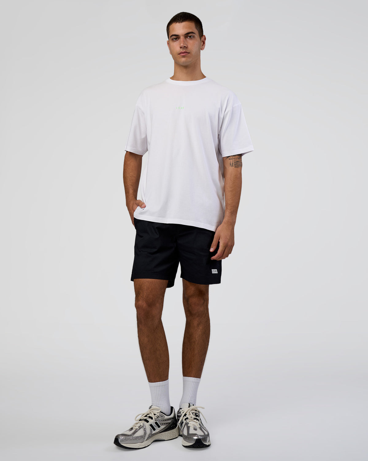 Man wearing Together We Rise FLXCotton Oversized Tee - White-Solar Lime | Model:Zoran | Size:L