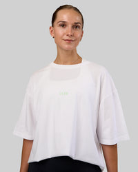 Woman wearing Together We Rise FLXCotton Oversized Tee - White-Solar Lime | Model:Myrte | Size:L | Thumbnail Index: 3