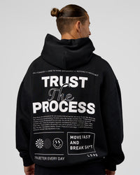 Man wearing Trust The Process Unisex Oversized Hoodie - Black-White | Model:Jaiden | Size:L | Thumbnail Index: 1