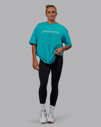 Woman wearing Unisex 1% Better FLXCotton Tee Oversize - Blue Bird-White | Thumbnail Index: 10