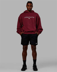 Man wearing Unisex 1% Better Hoodie Oversize - Cranberry-White | Thumbnail Index: 7