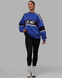 Woman wearing Unisex A-Team Sweater Oversize - Power Cobalt-Black | Thumbnail Index: 10