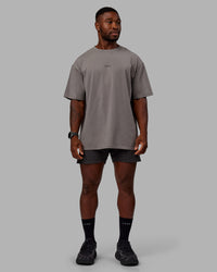 Man wearing Unisex Leg It FLXCotton Tee Oversize - Storm Front-Black | Thumbnail Index: 7