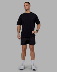 Man wearing Unisex Lift-Up FLXCotton Tee Oversize - Black-Fuschia Pink | Thumbnail Index: 10