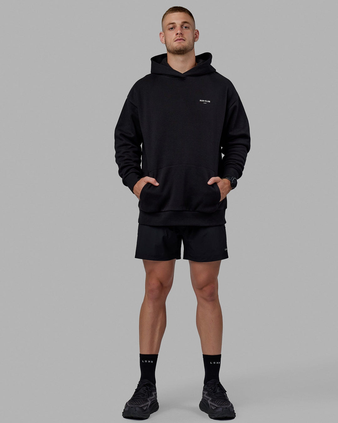 Man wearing Unisex RUN-CLUB Hoodie Oversize - Black - view 5