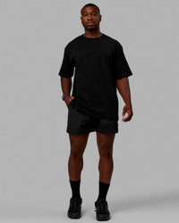 Man wearing Unisex Stamped 2.0 Heavyweight Tee Oversize - Black | Thumbnail Index: 8