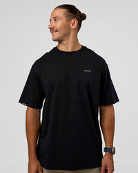Man wearing Unisex Strike Through FLXCotton Tee Oversize - Black-Candy Pink | Model:Jaiden | Size:L | Thumbnail Index: 1