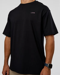 Man wearing Unisex Strike Through FLXCotton Tee Oversize - Black-Candy Pink | Model:Jaiden | Size:L | Thumbnail Index: 5