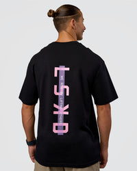 Man wearing Unisex Strike Through FLXCotton Tee Oversize - Black-Candy Pink | Model:Jaiden | Size:L | Thumbnail Index: 0