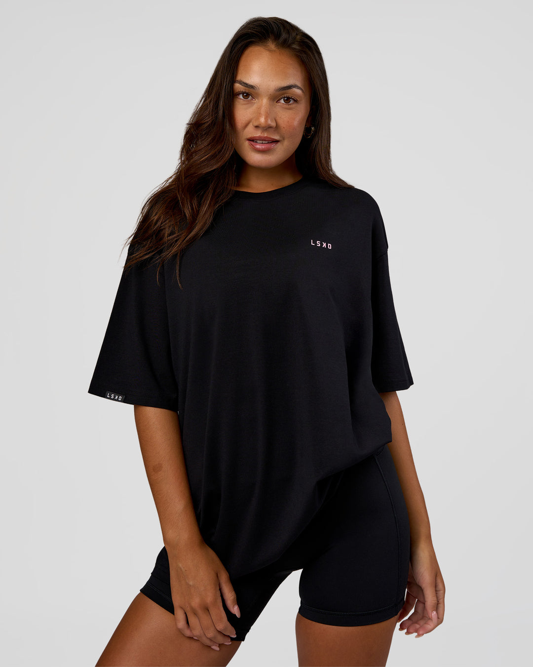 Woman wearing Unisex Strike Through FLXCotton Tee Oversize - Black-Candy Pink | Model:Kirstyn | Size:L - view 4